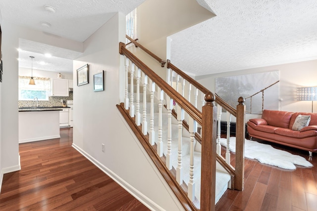 7672 Tullymore Dr, Dublin, OH 43016 - stairway with wood finished floors and a textured ceiling