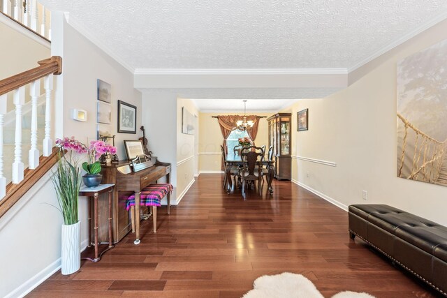 7672 Tullymore Dr, Dublin, OH 43016 - dining room with wood finished floors, a chandelier, stairs, a textured ceiling, and ornamental molding