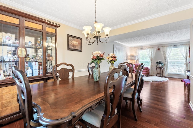 7672 Tullymore Dr, Dublin, OH 43016 - dining area with a textured ceiling, a chandelier, dark wood-style floors, and ornamental molding
