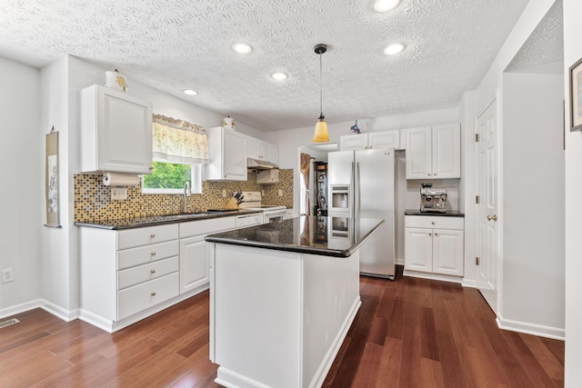 7672 Tullymore Dr, Dublin, OH 43016 - kitchen featuring electric stove, stainless steel fridge with ice dispenser, dark wood-style flooring, dark countertops, and white cabinetry