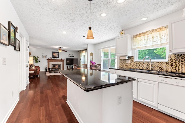 7672 Tullymore Dr, Dublin, OH 43016 - kitchen with white dishwasher, ceiling fan, a textured ceiling, tasteful backsplash, and a center island