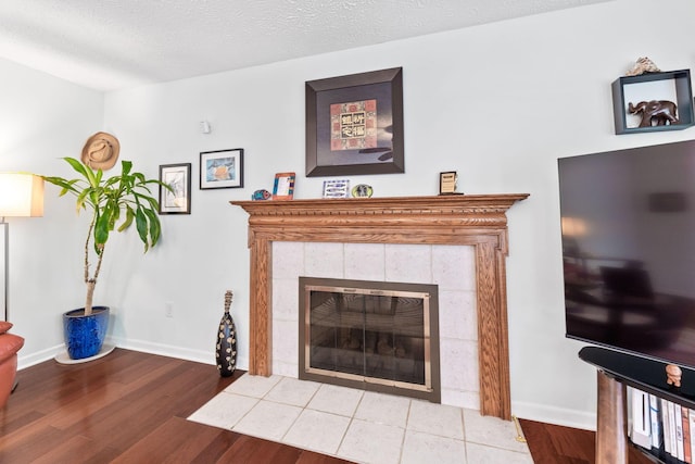7672 Tullymore Dr, Dublin, OH 43016 - living room with a tiled fireplace and wood finished floors