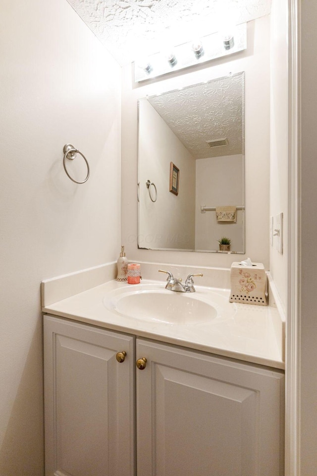 7672 Tullymore Dr, Dublin, OH 43016 - bathroom featuring a textured ceiling and vanity