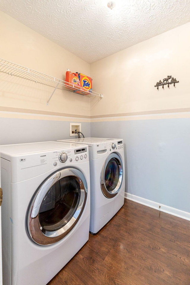 7672 Tullymore Dr, Dublin, OH 43016 - laundry room featuring washer and dryer, dark wood finished floors, and a textured ceiling