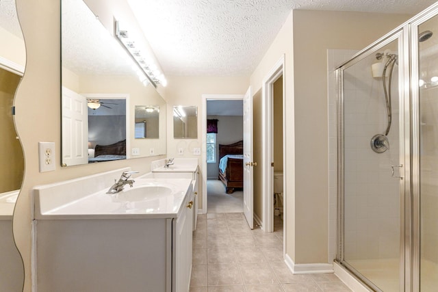7672 Tullymore Dr, Dublin, OH 43016 - full bathroom featuring connected bathroom, double vanity, ceiling fan, a stall shower, and a textured ceiling