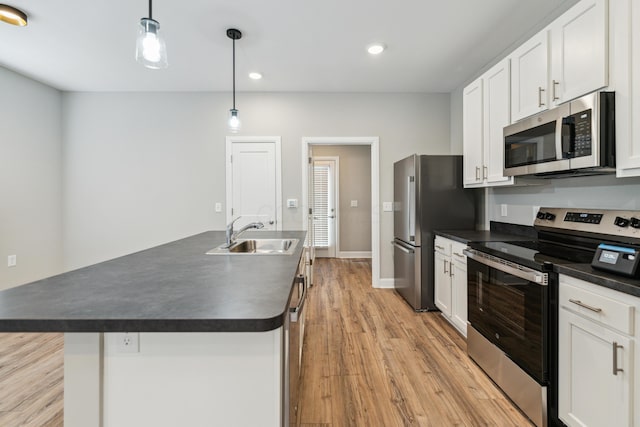 273 S Grubb St S Unit 273, Columbus, OH 43222 - kitchen with stainless steel appliances, dark countertops, light wood finished floors, white cabinetry, and recessed lighting