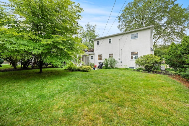 2681 Montcalm Rd, Columbus, OH 43221 - back of house with stucco siding and a lawn