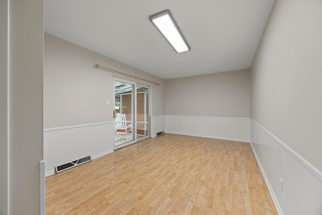 2681 Montcalm Rd, Columbus, OH 43221 - empty room featuring wood finished floors and a wainscoted wall