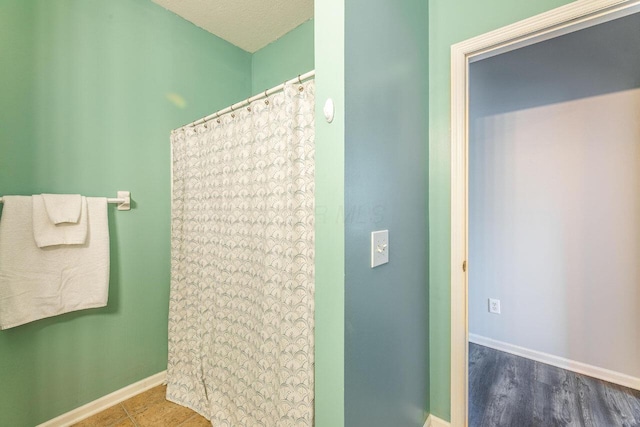 6028 Inishmore Ln, Dublin, OH 43017 - bathroom with baseboards and a shower with shower curtain