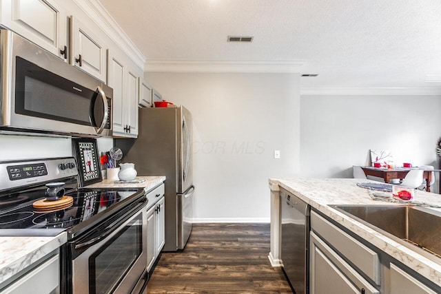 6028 Inishmore Ln, Dublin, OH 43017 - kitchen with stainless steel appliances, crown molding, dark wood finished floors, light countertops, and white cabinets