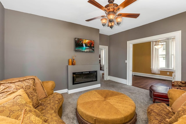 840 N Broad St, Lancaster, OH 43130 - living room featuring a baseboard radiator, a ceiling fan, carpet floors, and a glass covered fireplace