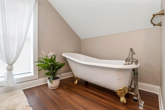 840 N Broad St, Lancaster, OH 43130 - bathroom featuring vaulted ceiling, a freestanding bath, and wood finished floors