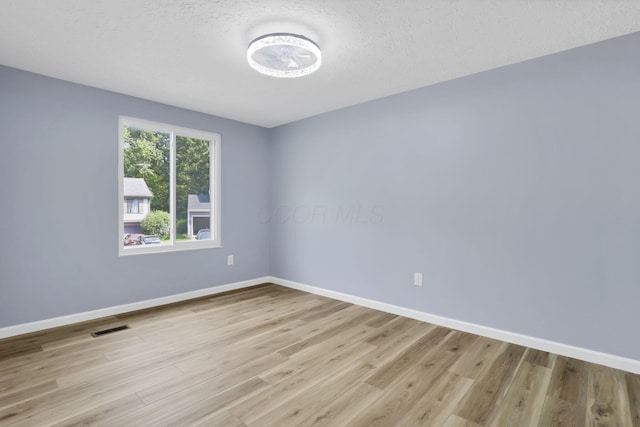 3751 Dolomite Dr, Columbus, OH 43230 - spare room with light wood-style floors and a textured ceiling