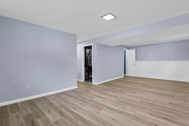 3751 Dolomite Dr, Columbus, OH 43230 - empty room featuring light wood-style flooring and a textured ceiling