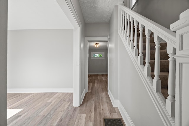 1765 S 8th St, Columbus, OH 43207 - staircase featuring wood finished floors and a textured ceiling