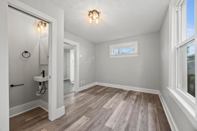 1765 S 8th St, Columbus, OH 43207 - spare room with a textured ceiling and wood finished floors