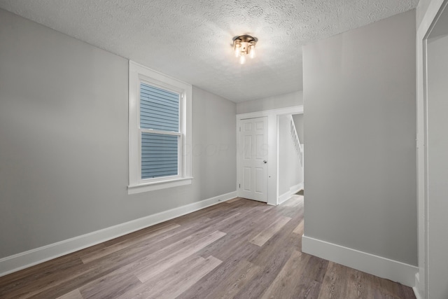 1765 S 8th St, Columbus, OH 43207 - spare room with a textured ceiling and wood finished floors