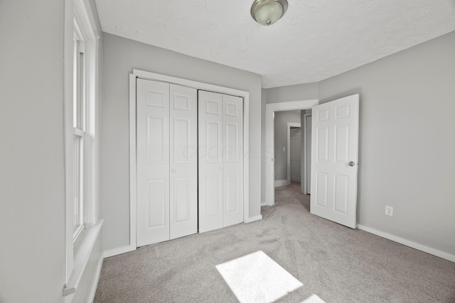 1765 S 8th St, Columbus, OH 43207 - unfurnished bedroom featuring carpet, a closet, and a textured ceiling