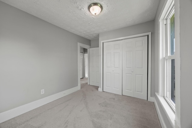 1765 S 8th St, Columbus, OH 43207 - unfurnished bedroom featuring carpet floors, a textured ceiling, and a closet