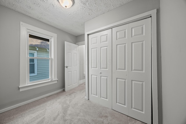 1765 S 8th St, Columbus, OH 43207 - unfurnished bedroom featuring carpet, a closet, and a textured ceiling