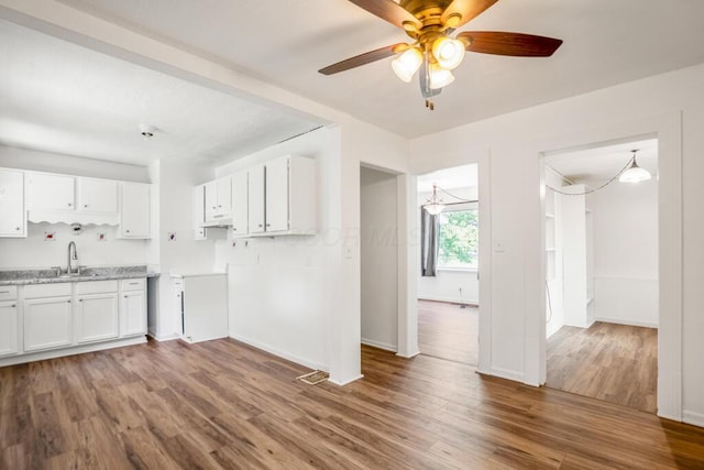 1717 Audrey Rd, Columbus, OH 43224 - kitchen featuring white cabinets, wood finished floors, light countertops, and a ceiling fan