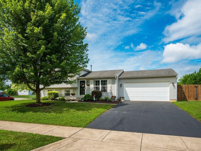 1225 El Toro Dr, Columbus, OH 43204 - tri-level home with asphalt driveway and an attached garage