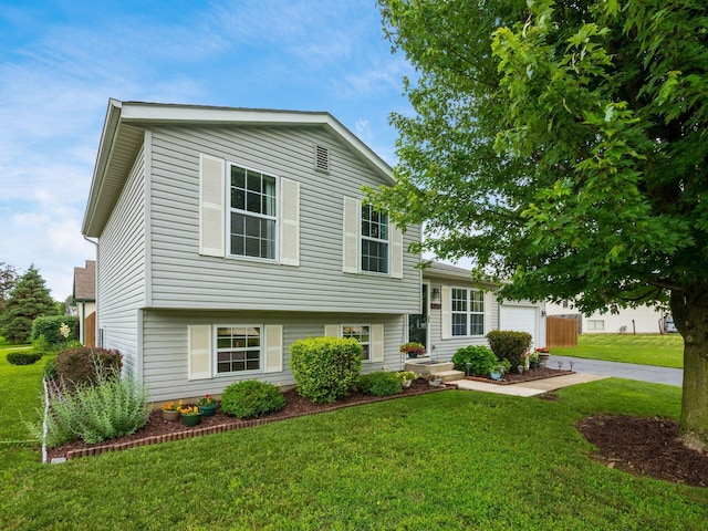 1225 El Toro Dr, Columbus, OH 43204 - split level home with a front yard, driveway, and a garage