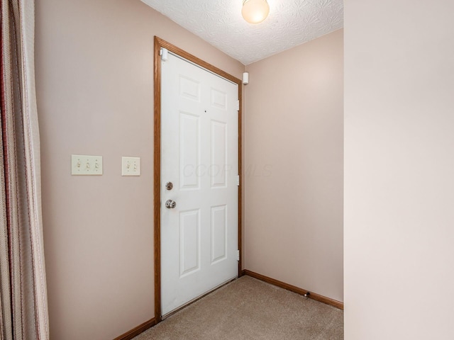 1225 El Toro Dr, Columbus, OH 43204 - doorway featuring light carpet and a textured ceiling