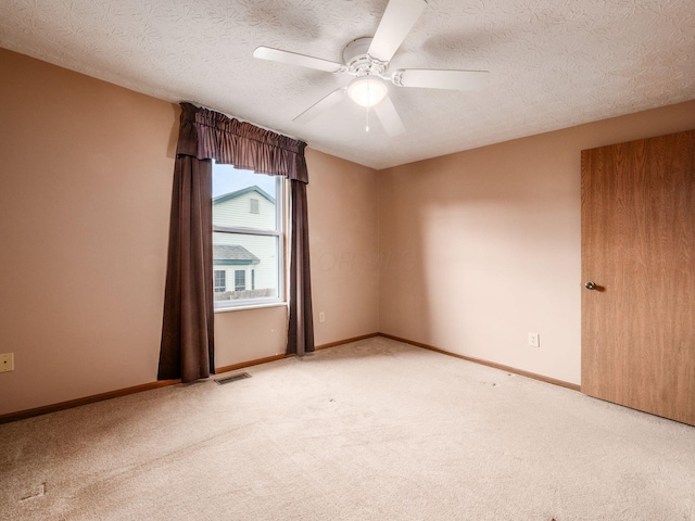 1225 El Toro Dr, Columbus, OH 43204 - spare room with carpet, ceiling fan, and a textured ceiling