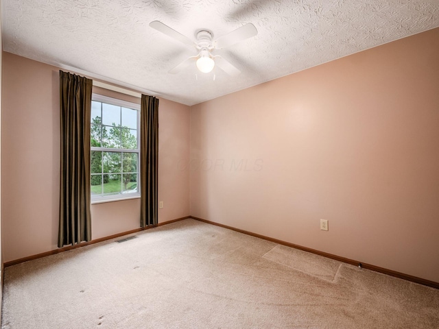 1225 El Toro Dr, Columbus, OH 43204 - spare room featuring light colored carpet, a ceiling fan, and a textured ceiling