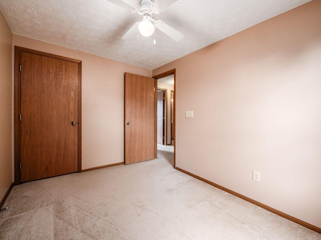 1225 El Toro Dr, Columbus, OH 43204 - unfurnished bedroom with light carpet, a closet, a textured ceiling, and a ceiling fan