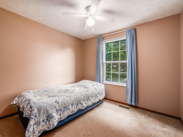 1225 El Toro Dr, Columbus, OH 43204 - bedroom featuring carpet floors, a ceiling fan, and a textured ceiling