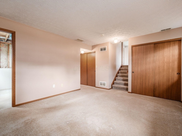 1225 El Toro Dr, Columbus, OH 43204 - empty room with stairway, carpet flooring, and a textured ceiling