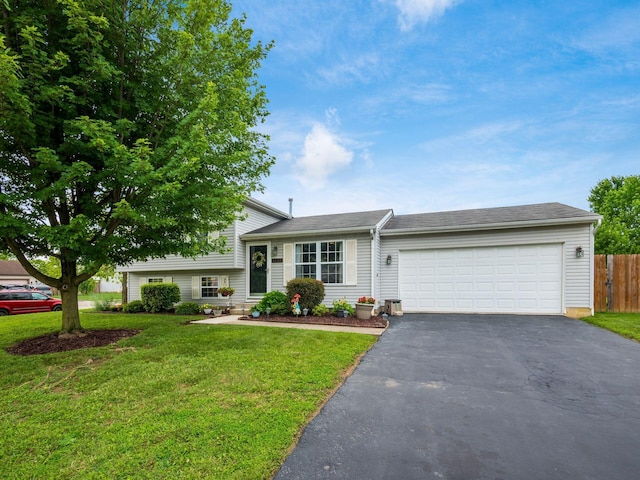 1225 El Toro Dr, Columbus, OH 43204 - tri-level home with asphalt driveway and a garage
