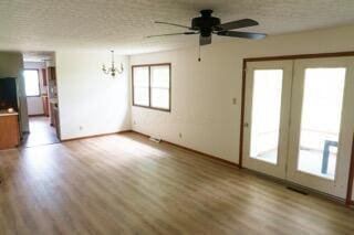 11280 US Highway 23, Lockbourne, OH 43137 - unfurnished living room with healthy amount of natural light, a chandelier, ceiling fan, and wood finished floors