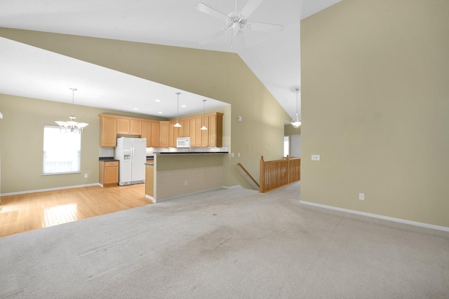 7931 Champaign Dr, Blacklick, OH 43004 - unfurnished living room with a chandelier, vaulted ceiling, light carpet, ceiling fan, and recessed lighting