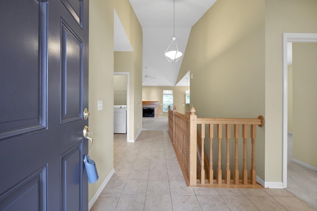 7931 Champaign Dr, Blacklick, OH 43004 - entrance foyer featuring washer / dryer, light tile patterned flooring, a fireplace, and high vaulted ceiling