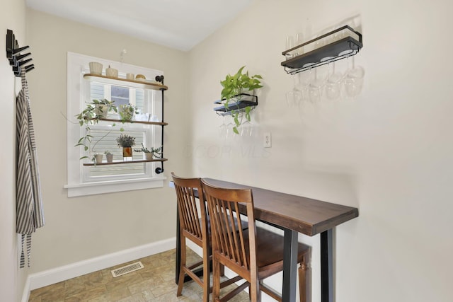 718 Harding Ave, Lancaster, OH 43130 - dining space featuring baseboards and stone finish floors