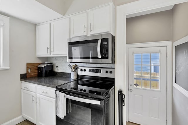 718 Harding Ave, Lancaster, OH 43130 - kitchen with stainless steel appliances, dark countertops, decorative backsplash, and white cabinets