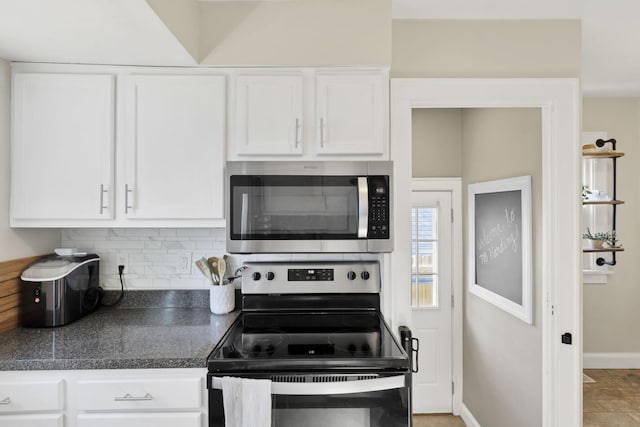 718 Harding Ave, Lancaster, OH 43130 - kitchen with appliances with stainless steel finishes, dark countertops, white cabinets, and tasteful backsplash