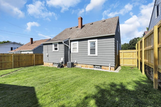 718 Harding Ave, Lancaster, OH 43130 - rear view of house featuring a chimney, roof with shingles, and a fenced backyard