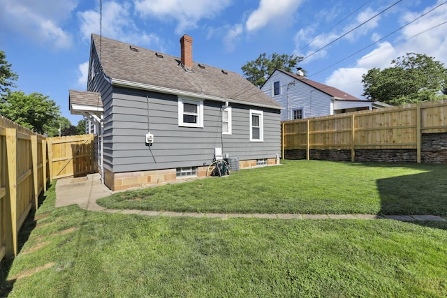 718 Harding Ave, Lancaster, OH 43130 - back of house with a chimney, a fenced backyard, and a shingled roof
