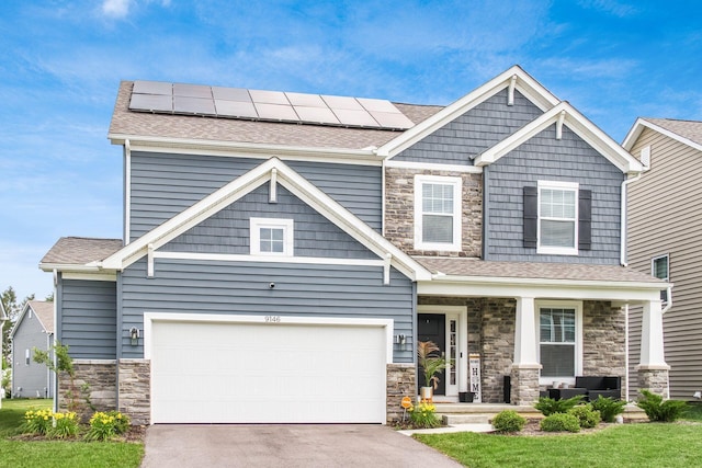 9146 Pennington Way, Blacklick, OH 43004 - craftsman house with stone siding, covered porch, roof mounted solar panels, and driveway