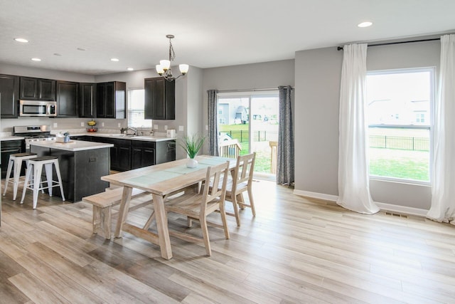 9146 Pennington Way, Blacklick, OH 43004 - dining space featuring plenty of natural light, a chandelier, light wood-type flooring, and recessed lighting