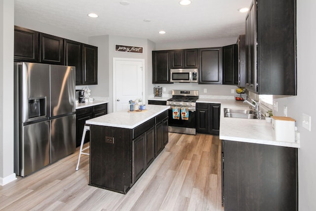 9146 Pennington Way, Blacklick, OH 43004 - kitchen featuring stainless steel appliances, light wood-type flooring, light countertops, a kitchen island, and recessed lighting