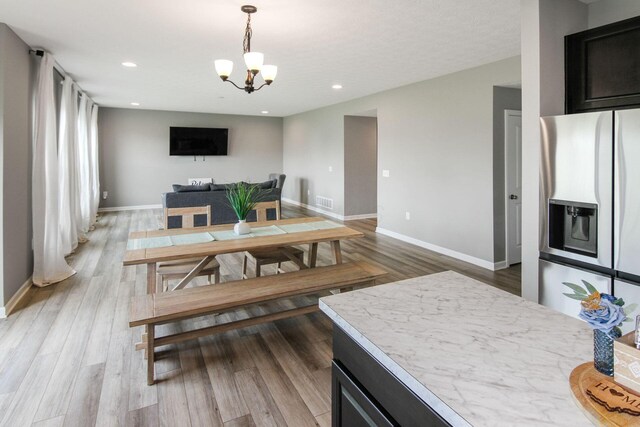 9146 Pennington Way, Blacklick, OH 43004 - dining space featuring a chandelier, light wood finished floors, and recessed lighting