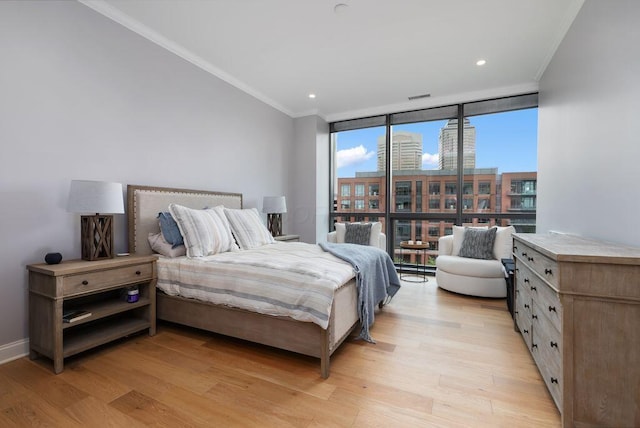 225 John H Mcconnell Blvd Unit 605, Columbus, OH 43215 - bedroom with a wall of windows, light wood finished floors, ornamental molding, recessed lighting, and a city view