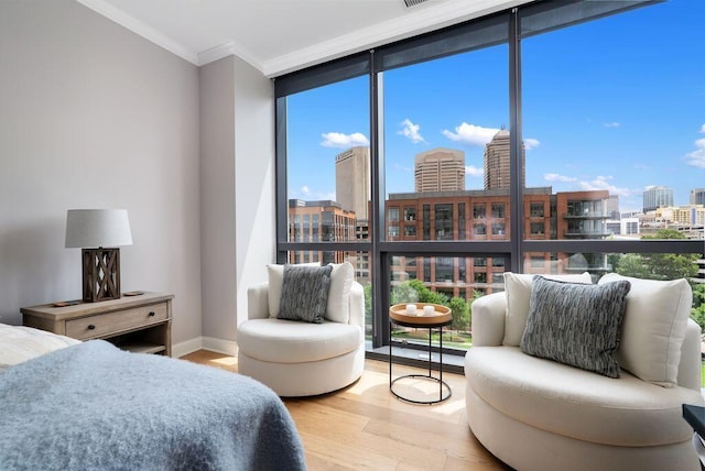 225 John H Mcconnell Blvd Unit 605, Columbus, OH 43215 - bedroom with a view of skyline, a wall of windows, wood finished floors, ornamental molding, and multiple windows