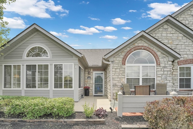 4188 Stoneworks Pl, New Albany, OH 43054 - view of front of house featuring stone siding and a shingled roof