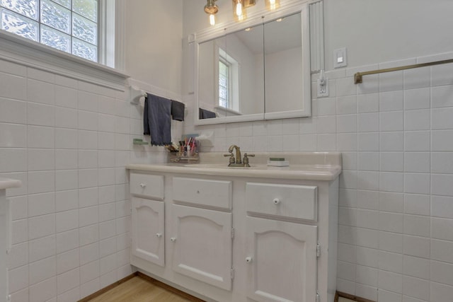 11620 Highland Park, Logan, OH 43138 - bathroom with tile walls, plenty of natural light, vanity, and wood finished floors